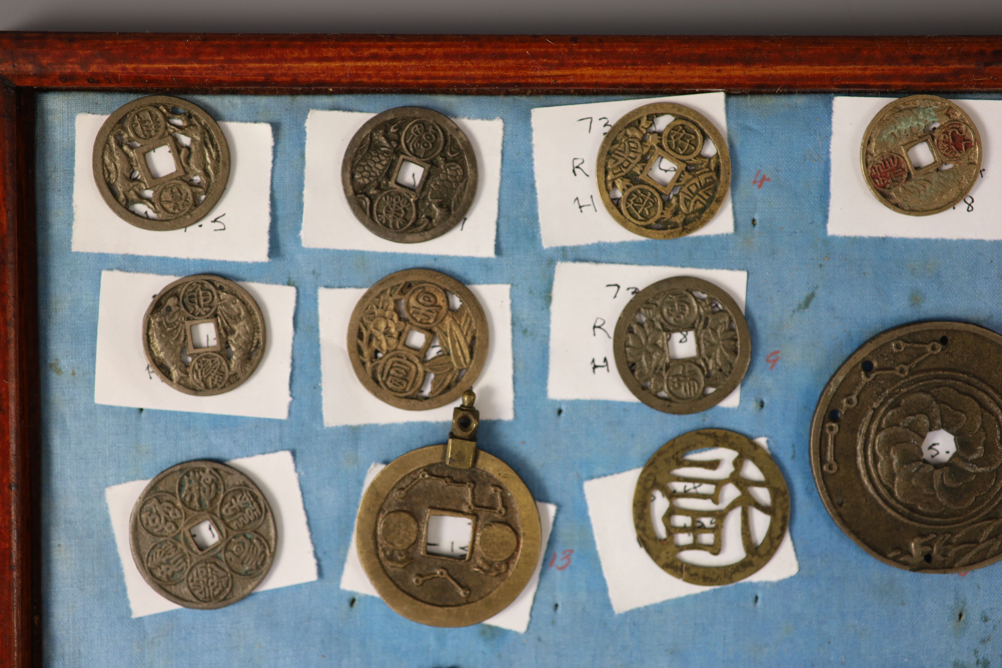 A group of 99 Korean bronze and metal amulets or charms, 19th/20th century